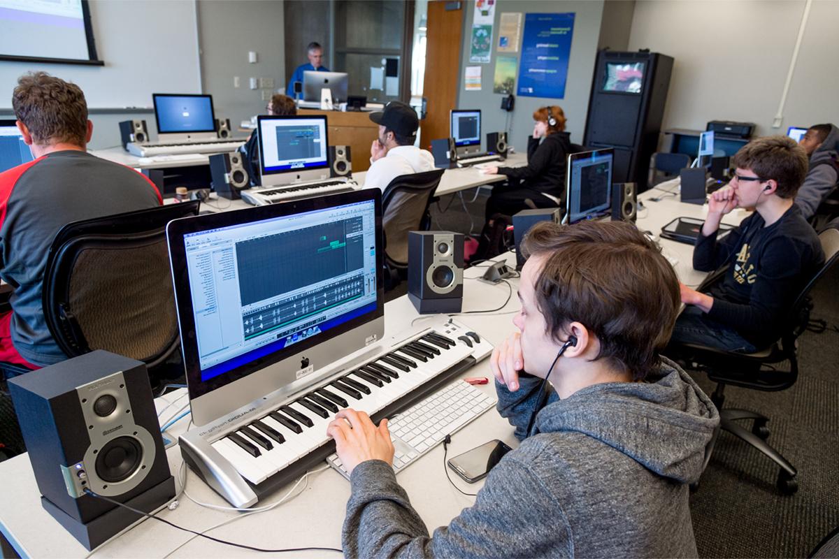 A Digital music class with students using keyboards and computers